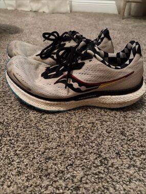 Saucony White Running Shoes with Black Checker Lining and Red-Yellow Accents